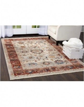 A living room with a rug on the floor and a chair.