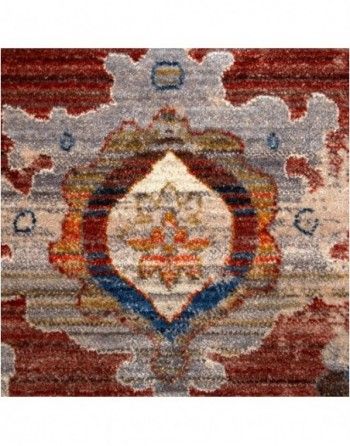 A close up of a rug with a circular pattern on it.