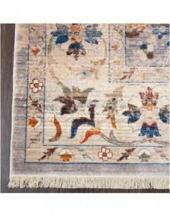 A rug with a floral pattern on it is on a wooden floor.