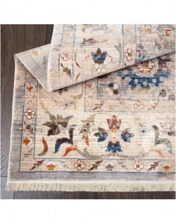 A rug with a floral pattern is sitting on a wooden floor.