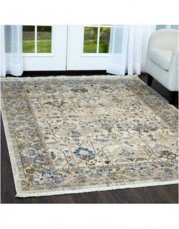 A rug is sitting on a wooden floor in a living room.