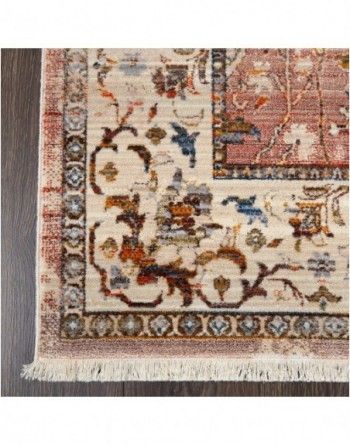 A rug with a floral pattern is sitting on a wooden floor.
