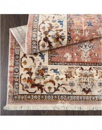 Two rugs are stacked on top of each other on a wooden floor.