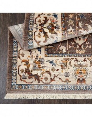 A rug with a floral pattern is sitting on top of a wooden floor.