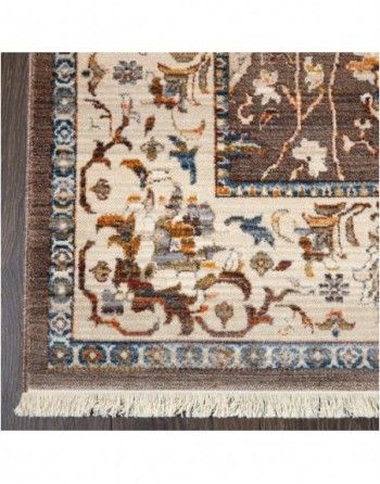 A rug with a floral pattern on it is sitting on a wooden floor.