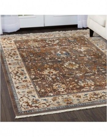 A rug is sitting on a wooden floor in a living room.