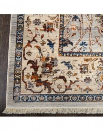 A rug with a floral pattern on it is on a wooden floor.