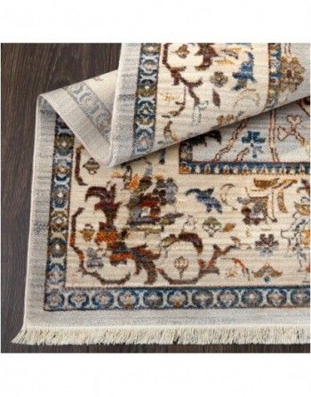 A rug with a floral pattern is sitting on a wooden floor.