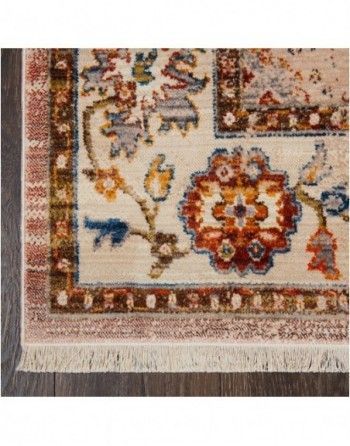 A rug with a floral pattern is sitting on a wooden floor.