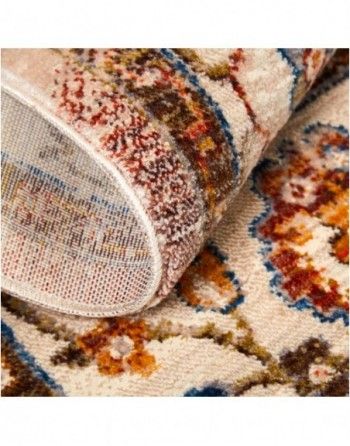 A close up of the back of a rug with a floral pattern.