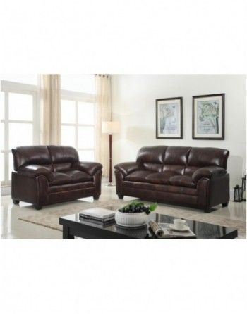 A living room with two brown leather couches and a coffee table.