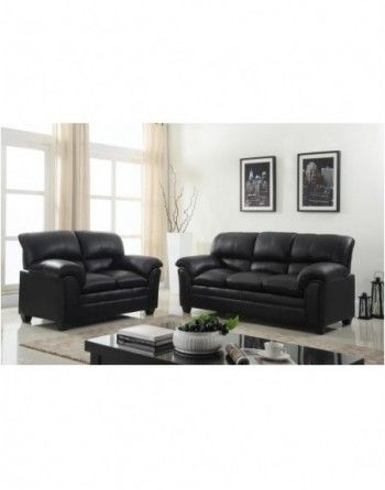 A living room with two black leather couches and a coffee table.