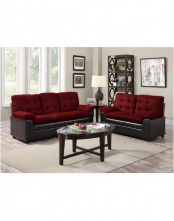 A living room with two red couches and a coffee table