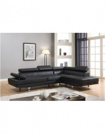 A living room with a black sectional couch and a coffee table