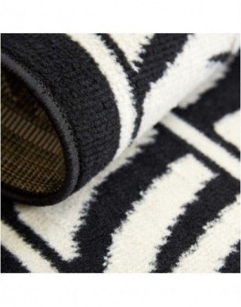 A black and white rug with a geometric pattern on it