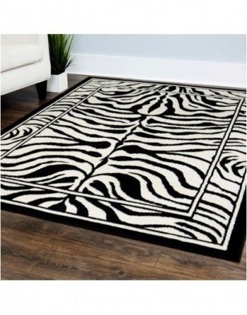 A black and white zebra print rug is on a wooden floor in a living room.