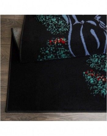 A black rug is sitting on a wooden floor.