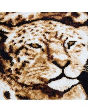 A close up of a leopard 's face on a rug.
