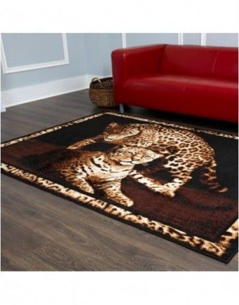 A living room with a red couch and a rug with a leopard on it