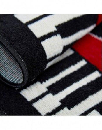 A black and white rug with piano keys on it