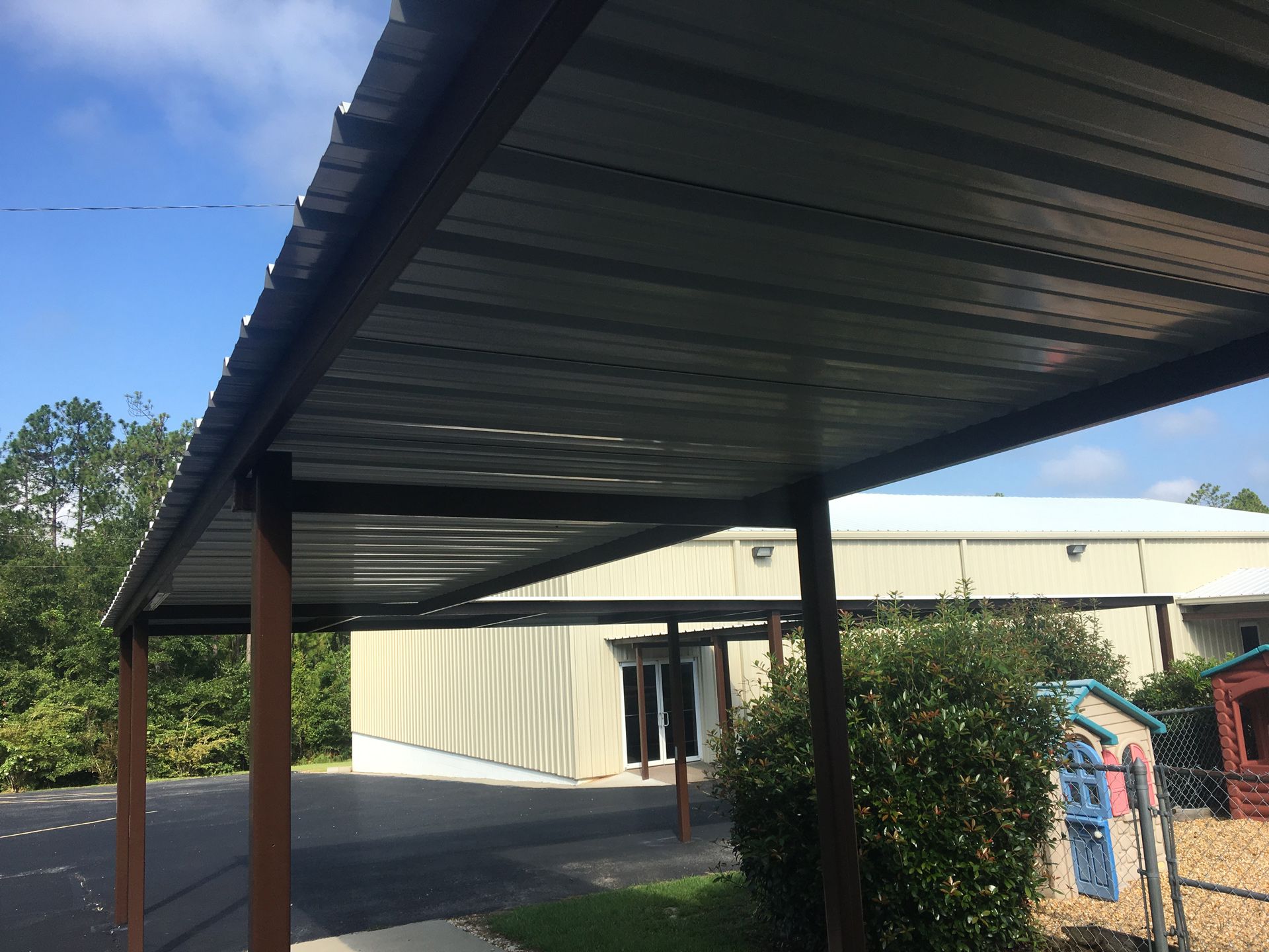 A metal covered walkway leading to a building