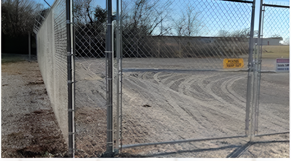 View of a chain link fence on a commercial property, installed by a commercial fence company. View of a chain link fence on a commercial property, installed by a commercial fence company.