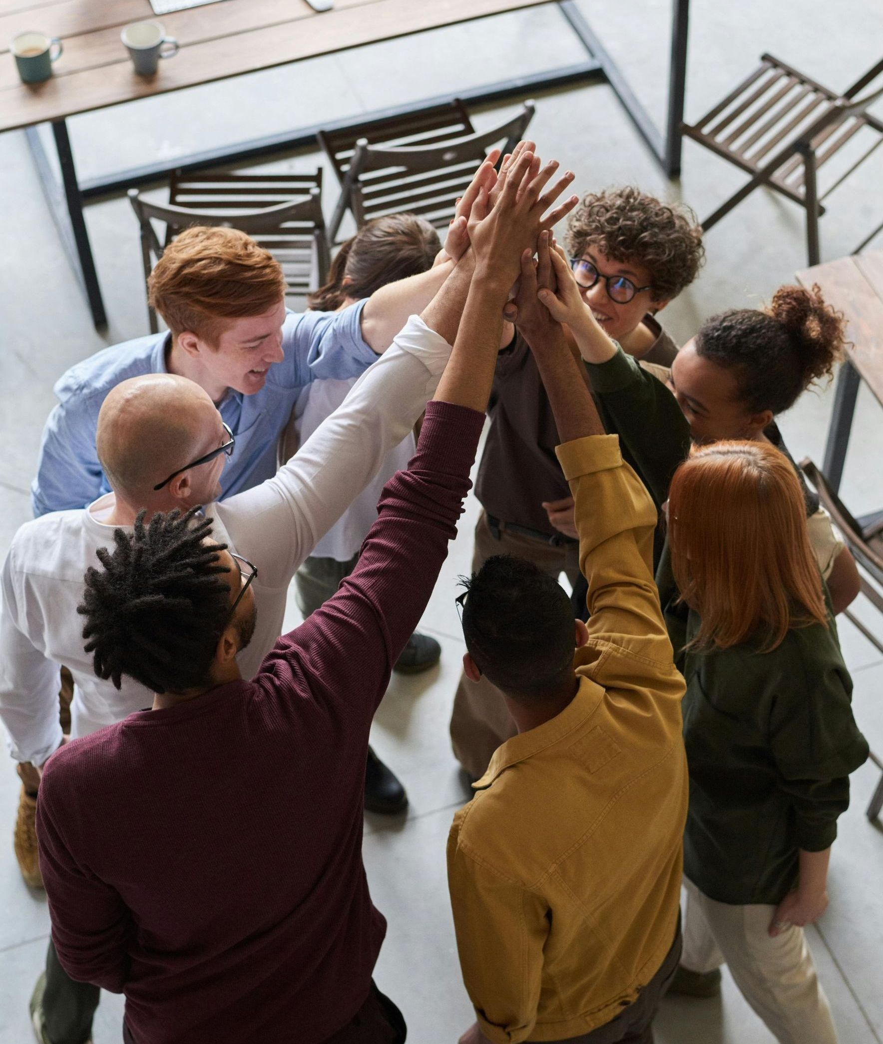 A group of people are giving each other a high five.
