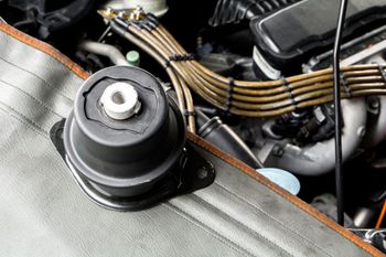 a close up of a motor mount under the hood of a car