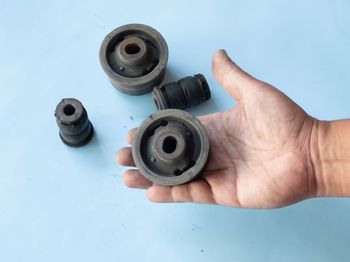 a person is holding a rubber bushing in his hand