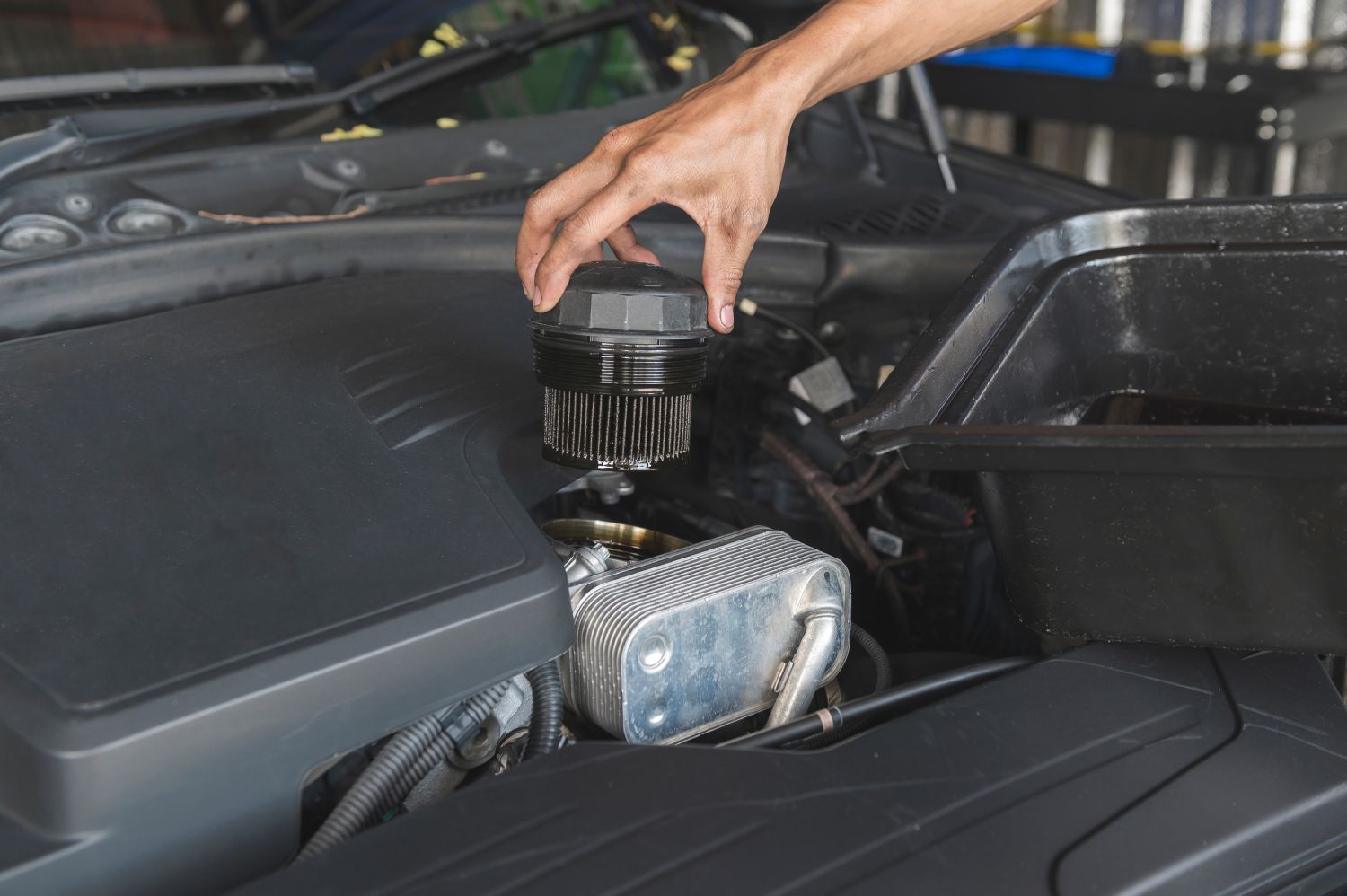 a person is opening the hood of a car in a garage