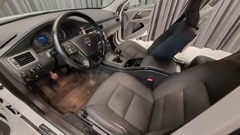 the interior of a white car with black seats and a steering wheel