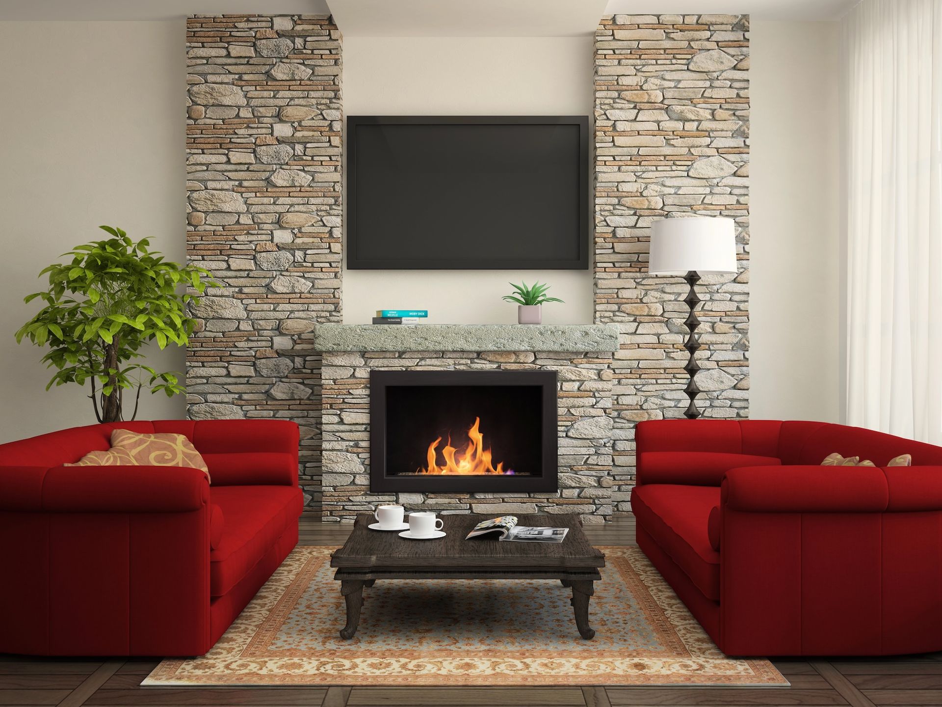 Living room with red sofas facing a stone fireplace with a TV above it; a coffee table sits in front.