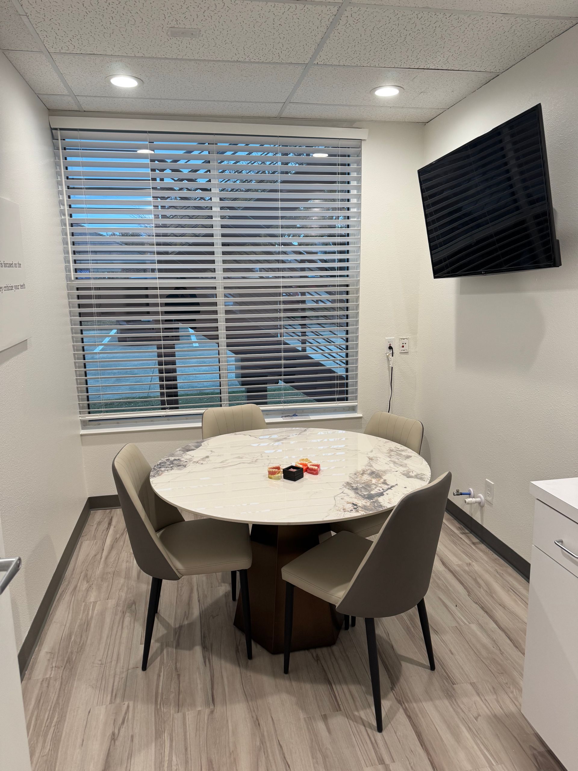A conference room with a round table and chairs