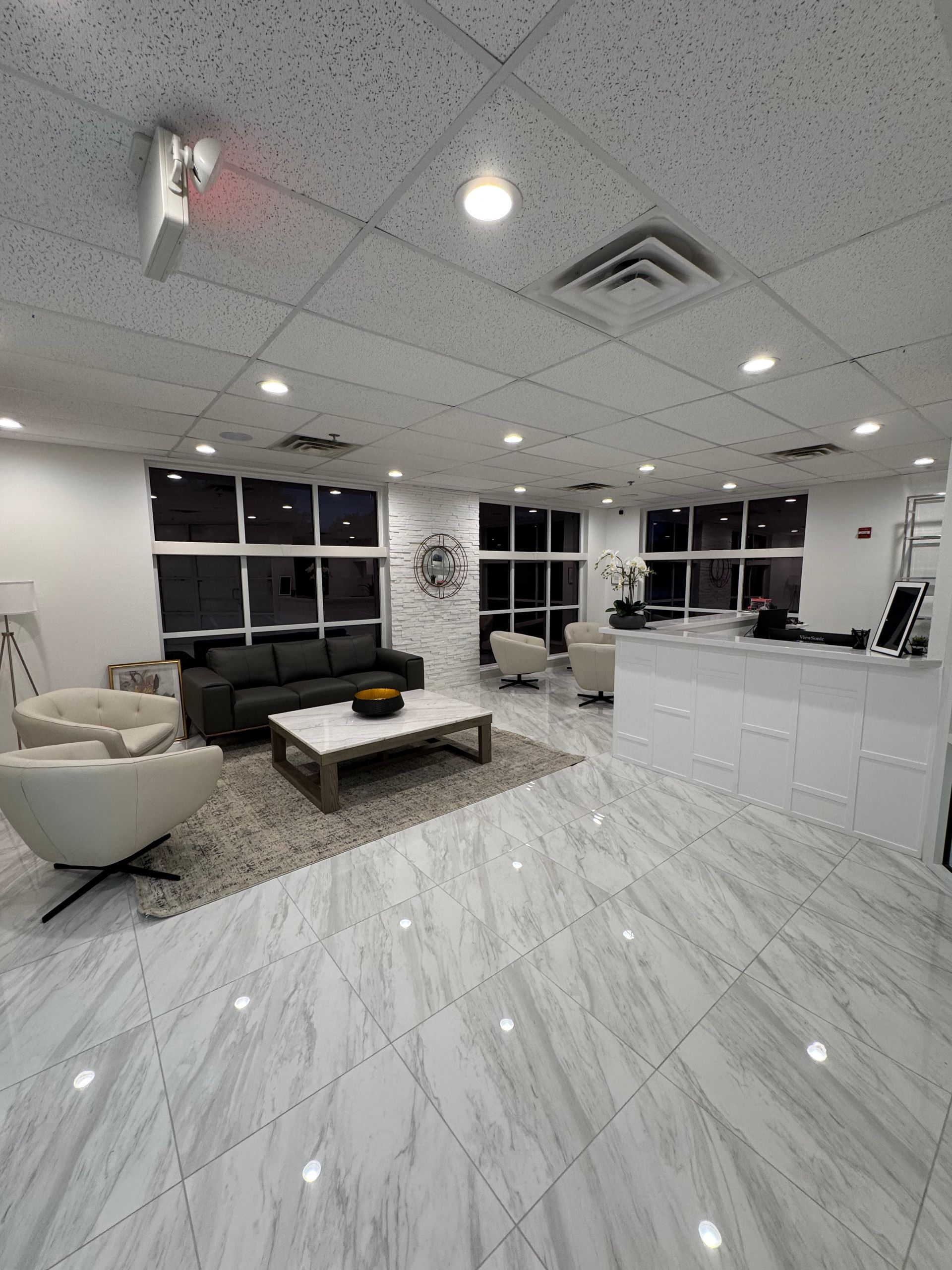 A living room with a couch , chairs and a coffee table