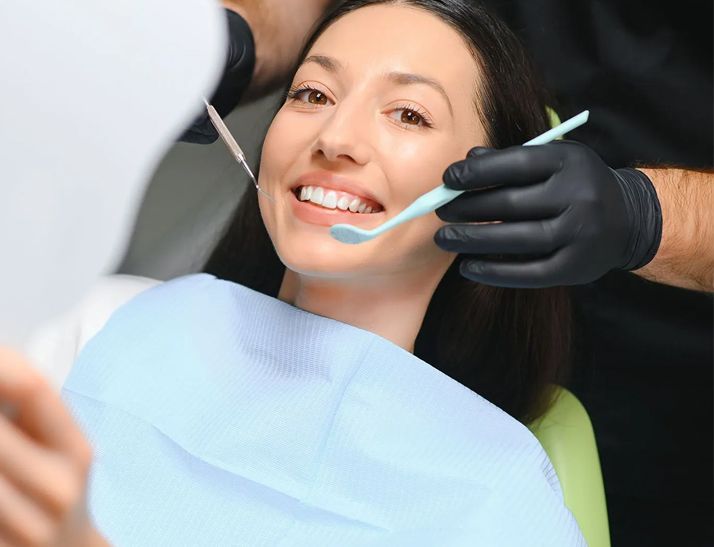 A close up of a woman smiling with her mouth open.