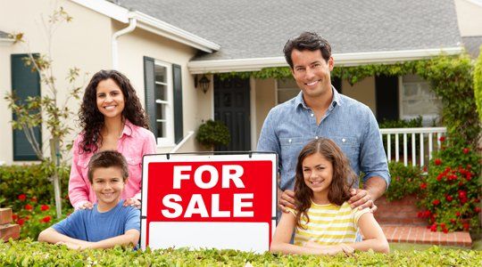 Sell Your Home — Family Outside Home with For Sale Sign in Louisiana