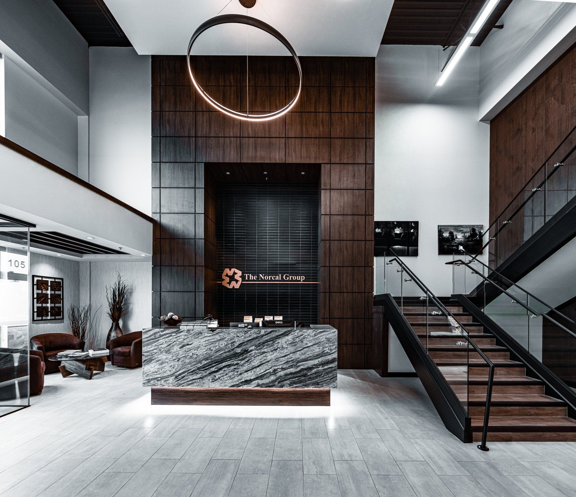 a large lobby with stairs and a reception desk