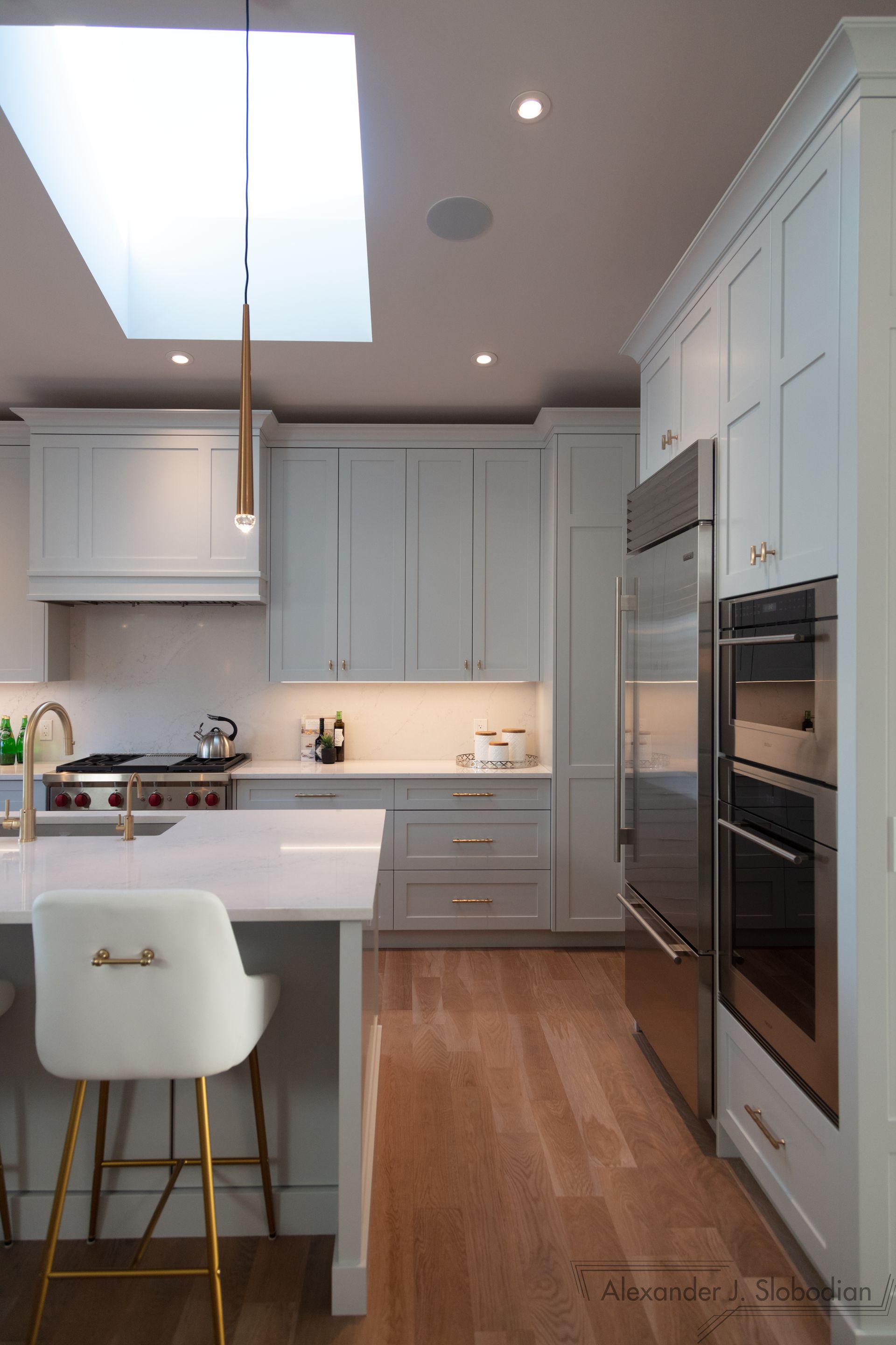 a large brick house with a lot of windows is sitting on top of a lush green lawn .