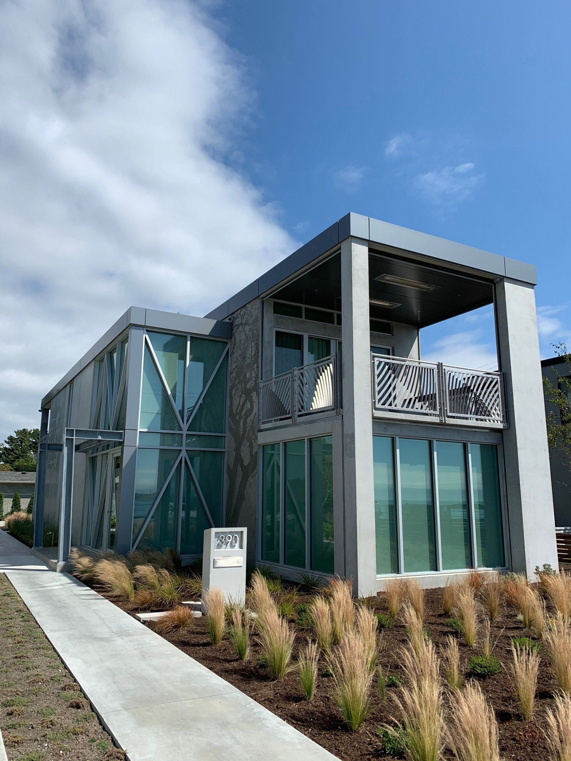a large modern house with a lot of windows and a balcony .