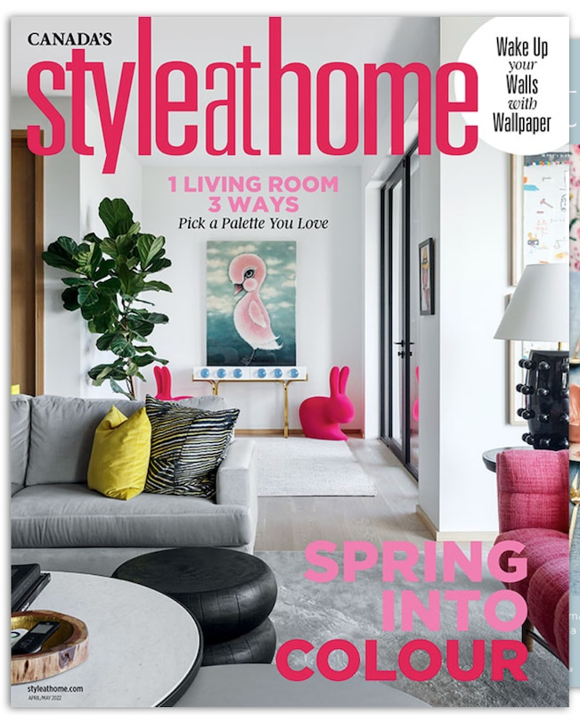 a living room with a couch and a table on the cover of a magazine .