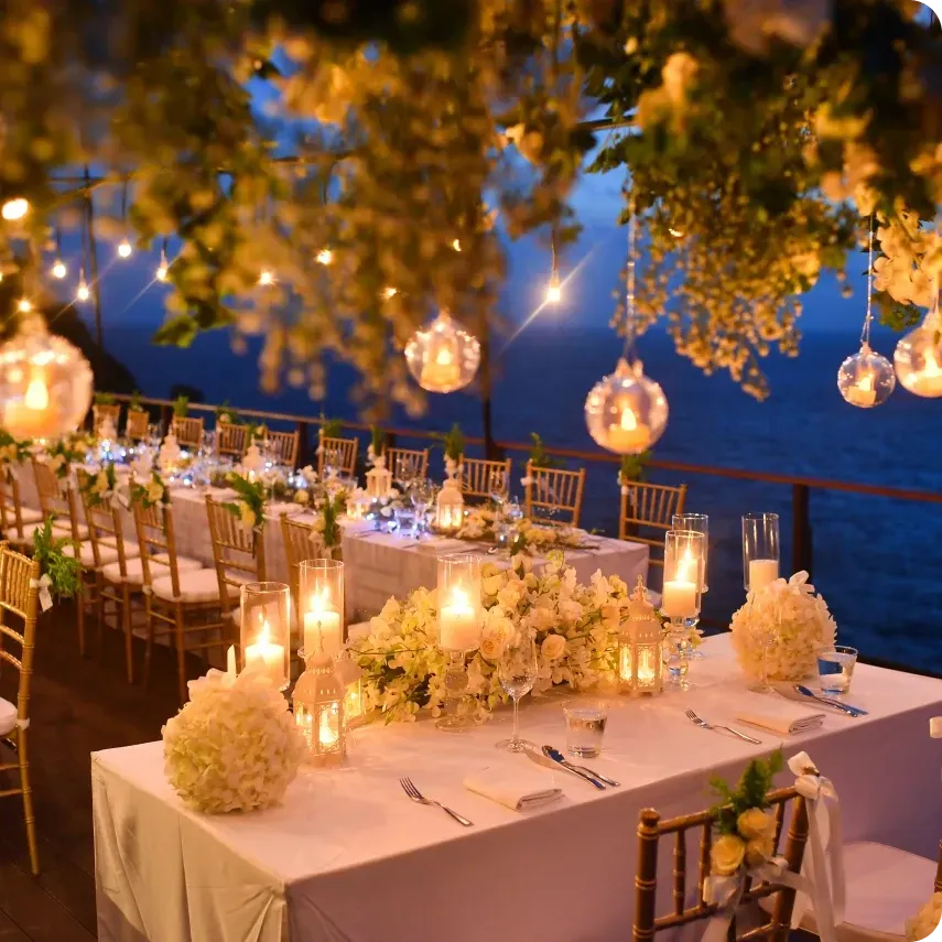 A long table with candles and flowers on it