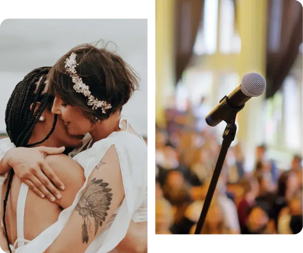 A couple kissing next to a microphone with a crowd in the background.