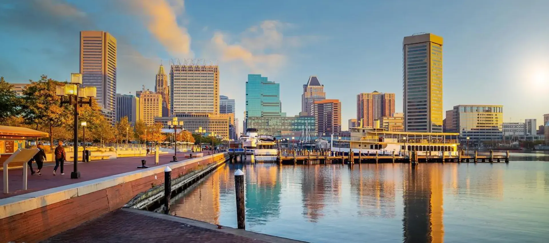 A city skyline with a dock in the foreground and a body of water in the background.