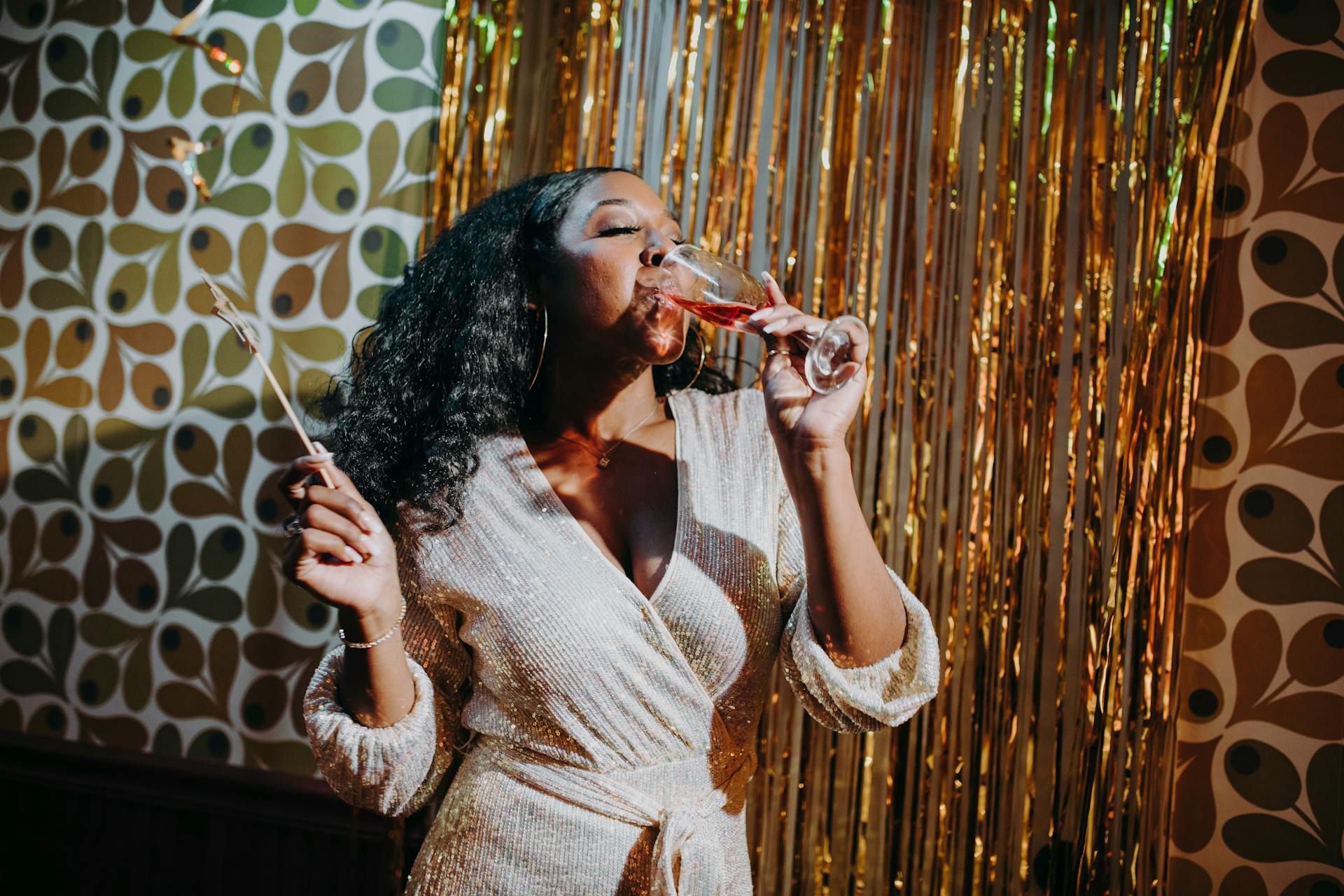 A Lady Drinking a Champagne in Party