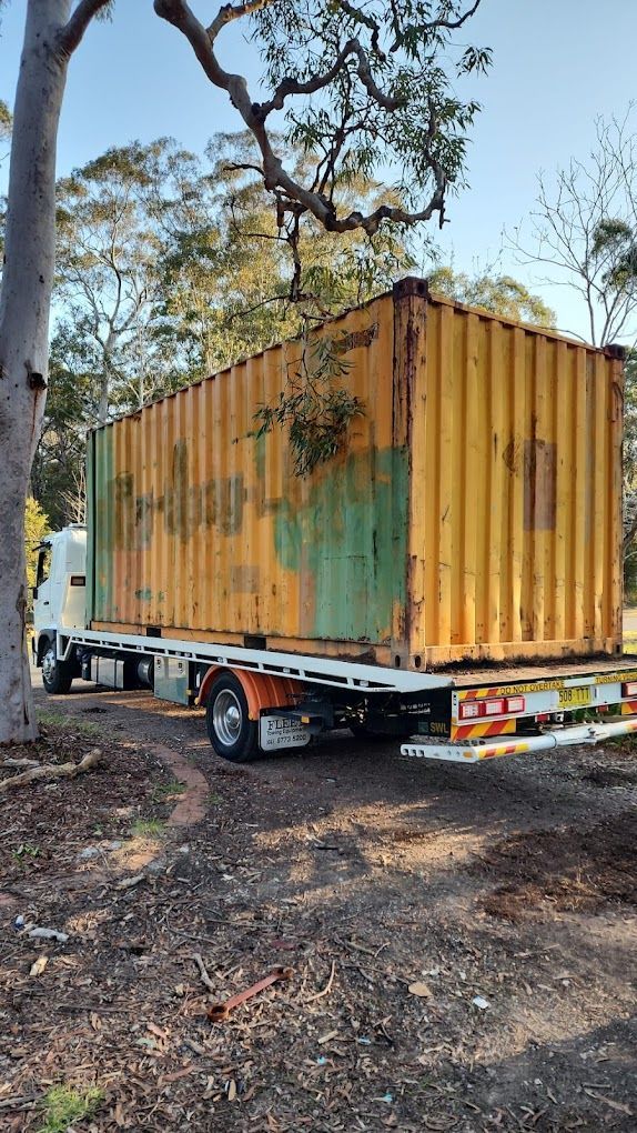 A Truck Is Being Loaded With A Container In A Warehouse — NCM Towing Newcastle In Broadmeadow, NSW