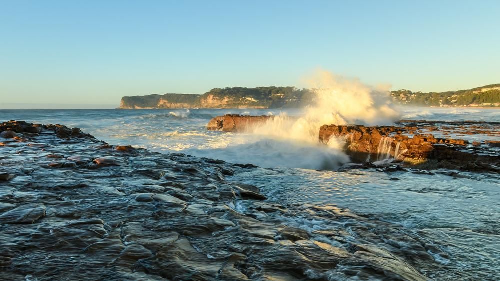The Waves Are Crashing Against The Rocks On The Beach — NCM Towing Newcastle In Central Coast, NSW