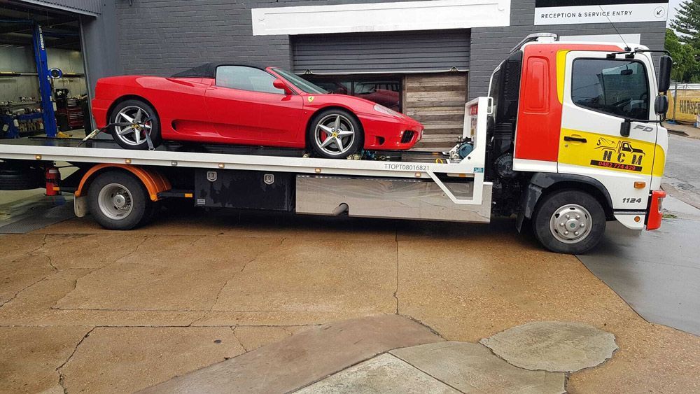 Truck Towing a Red Car