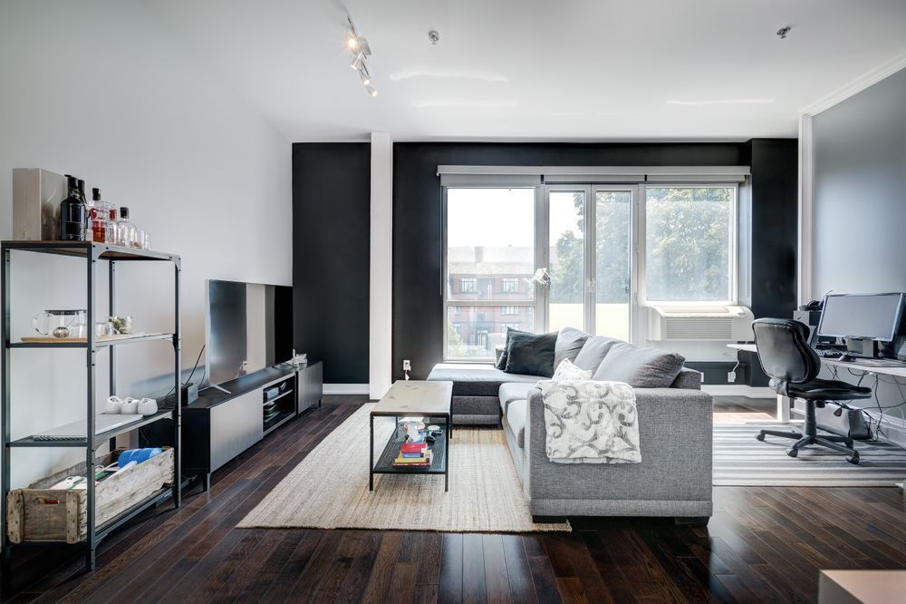 A Living Room With A Couch, Television, Desk And Chair — Coastal Vibez In Sydney, NSW
