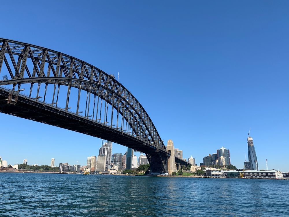 A Bridge Over A Body Of Water With A City In The Background — Coastal Vibez In Sydney, NSW