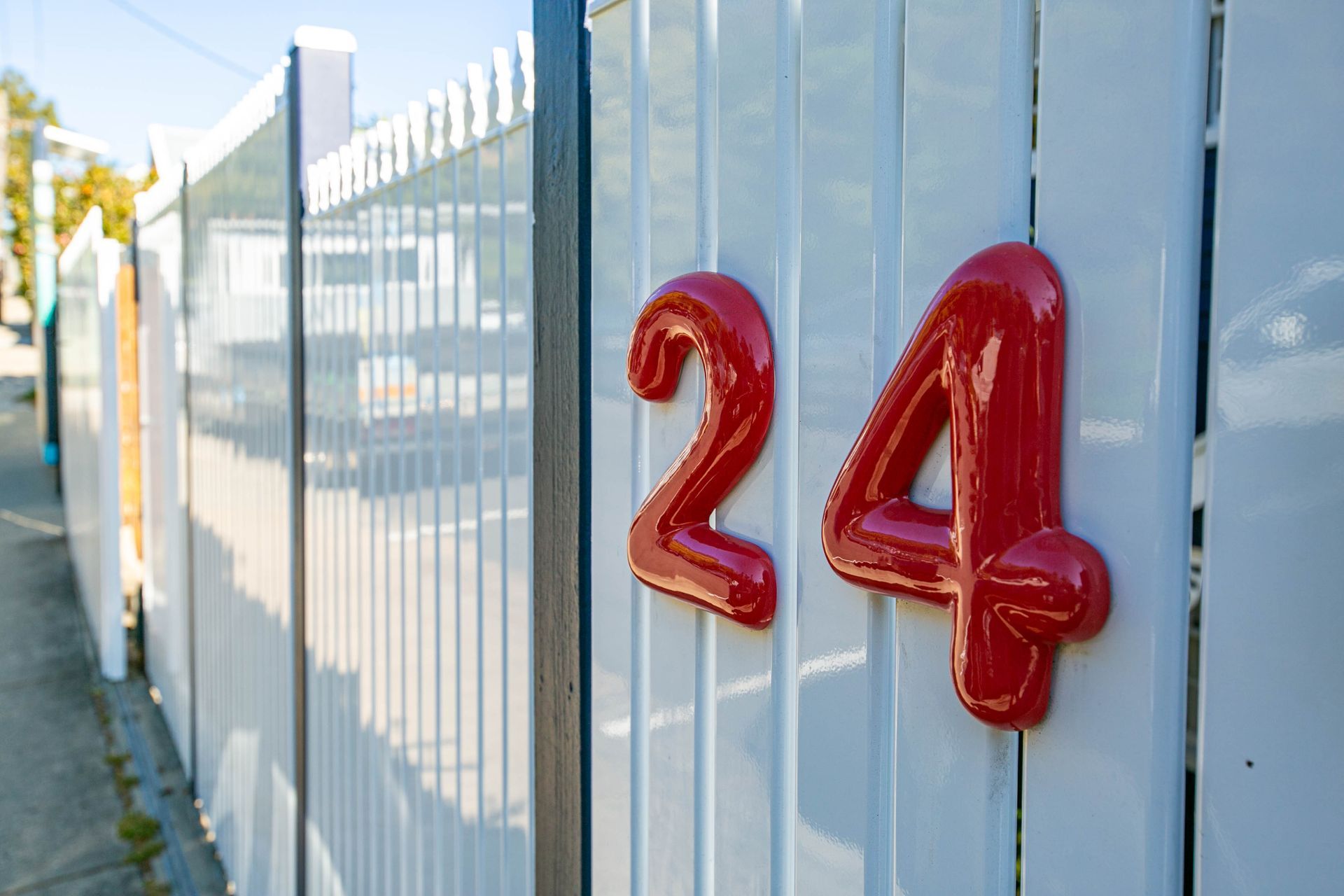 The number 24 in red on a white gate— Coastal Vibez In The Entrance, NSW